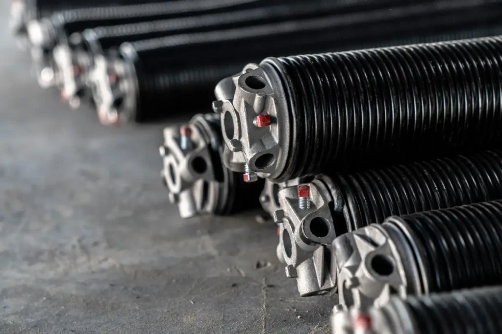Brand new garage door replacement springs in their packaging, ready for installation by a professional technician