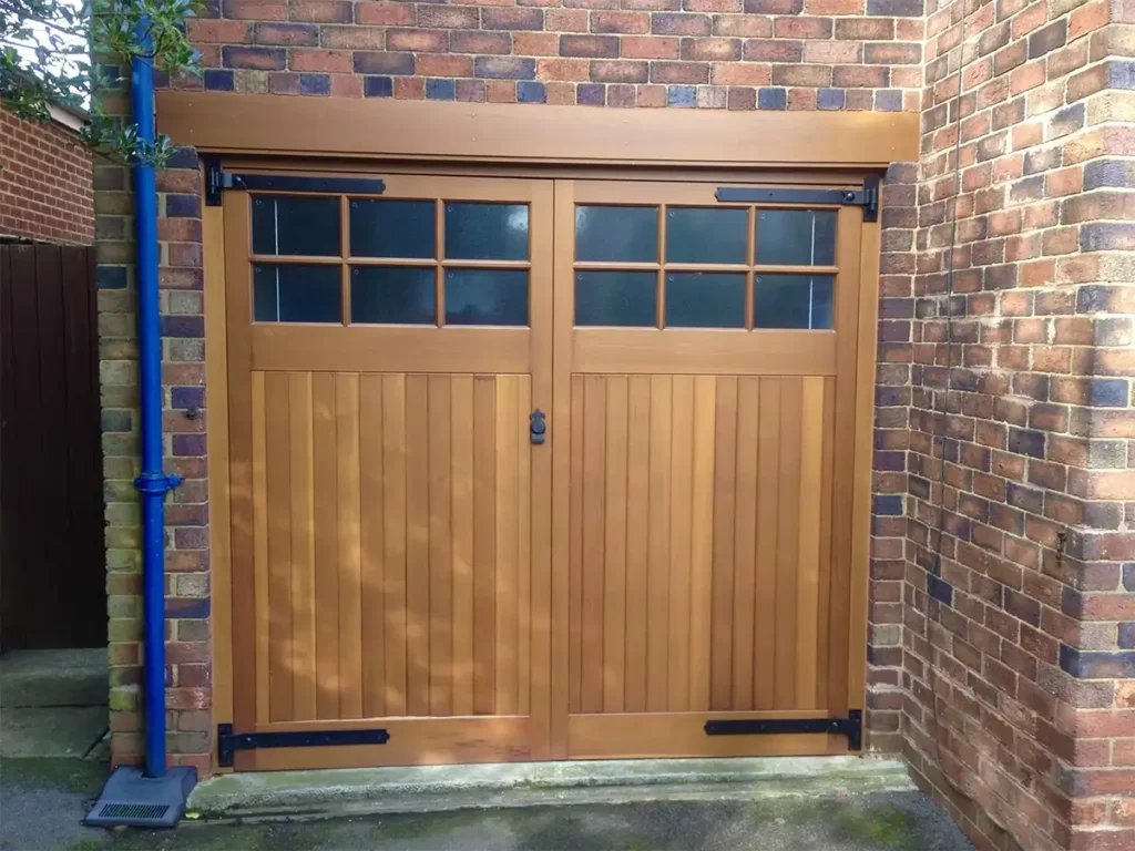 Cedar timber side-hinged garage door with warm natural wood grain on a residential property