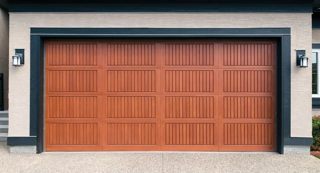 Fiberglass double garage door with wooden finish on a residential property, replicating the look of timber without the maintenance