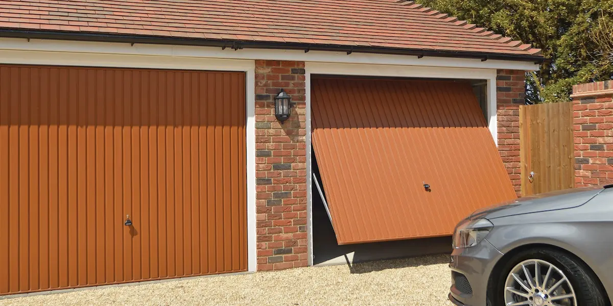 Garador brown up-and-over garage door in a classic warm finish with a traditional panelled design