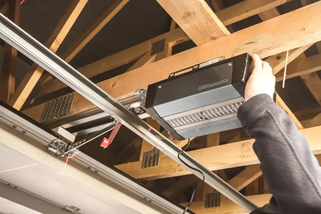Garage door automation motor enclosure showing the motor unit and drive mechanism on a residential garage door opener