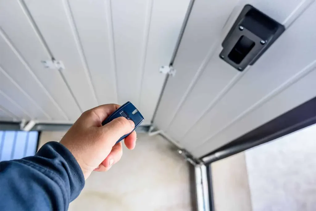 Garage door remote control and photoelectric safety sensor on a residential garage door