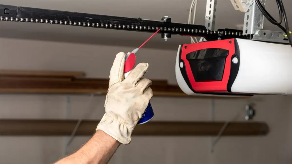 Lubricating a garage door automation track with a silicone-based lubricant, showing the application process on the moving parts of the track system