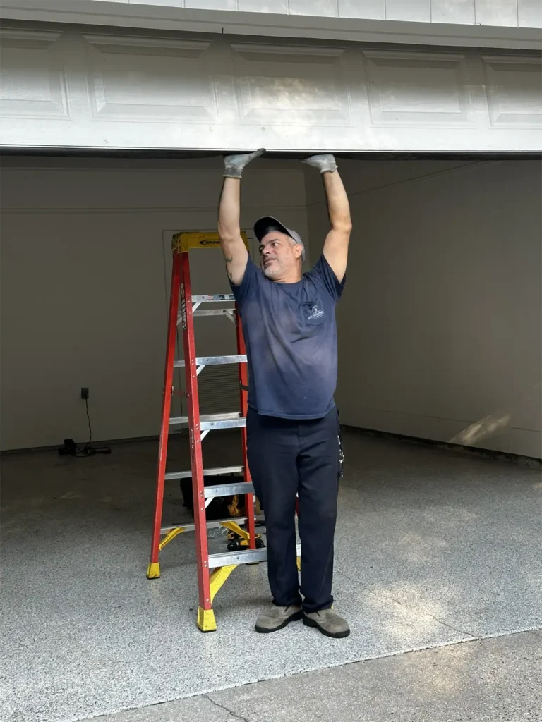 Testing a garage door emergency stop with an object placed in the door's path to trigger the auto-reverse safety mechanism